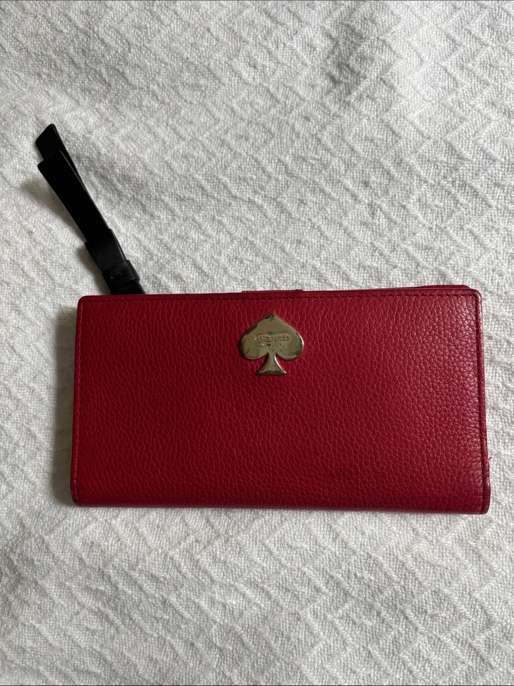 kate spade red pebbled leather zip wristlet with black strap